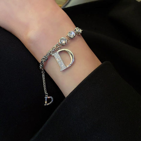 a woman weraing on her left wrist a Diamond Letter D Fringe Bracelet