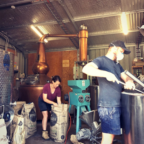 Bree and Leigh working in their shed distillery on a mash day