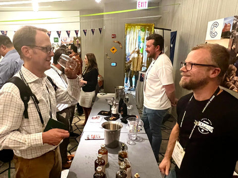 Leigh serving tasting of Backwoods whisky at the Chicago conference