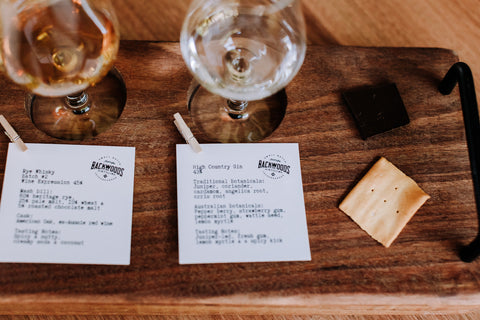 A tasting paddle of whisky with crackers and dark chocolate.