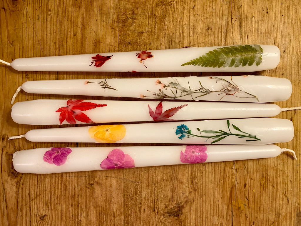 Candles decorated using pressed flowers
