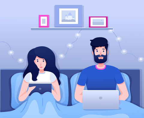 A man and women using there gadgets as they are sleep deprived