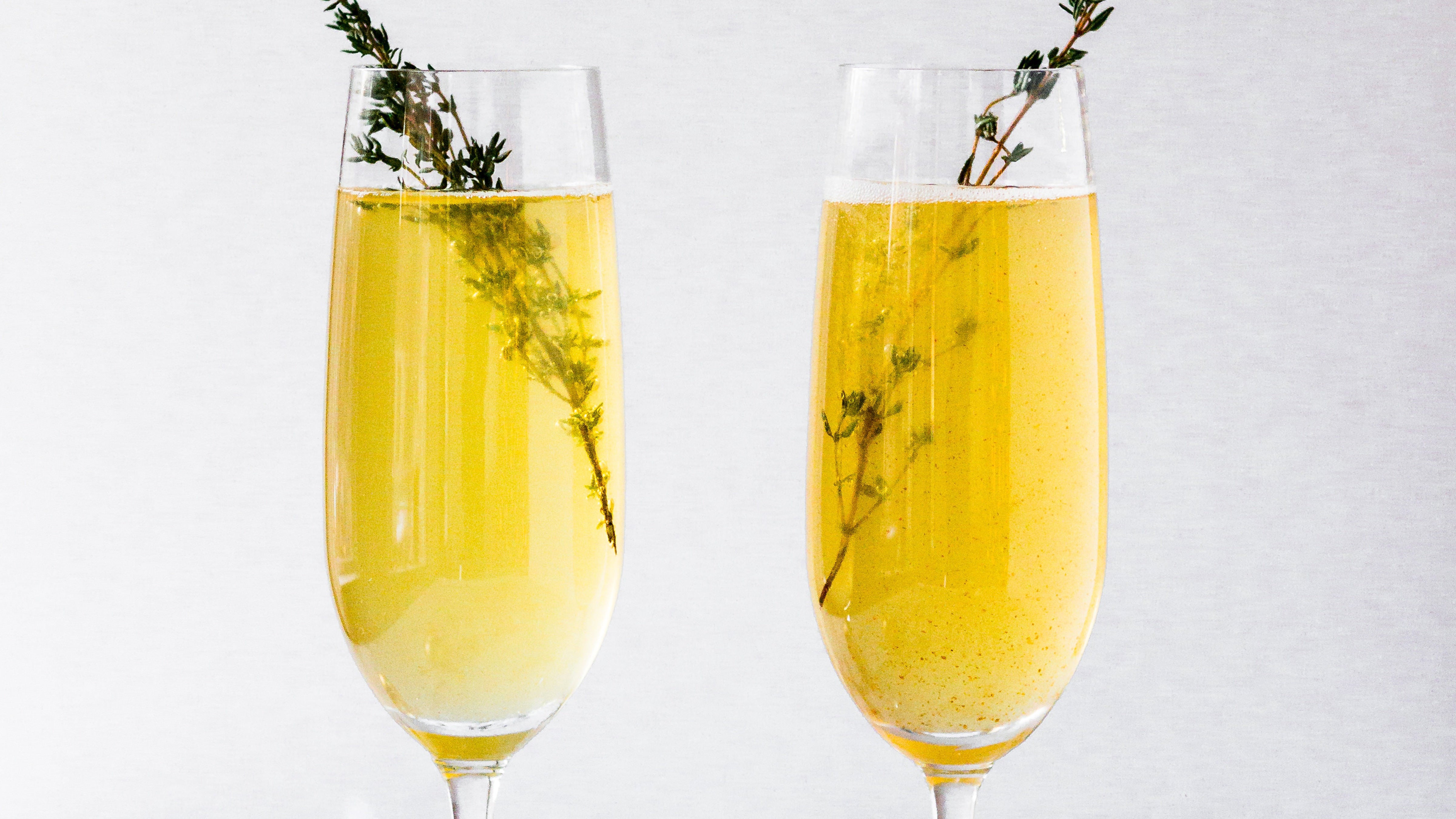 Two rosemary grapefruit mimosas