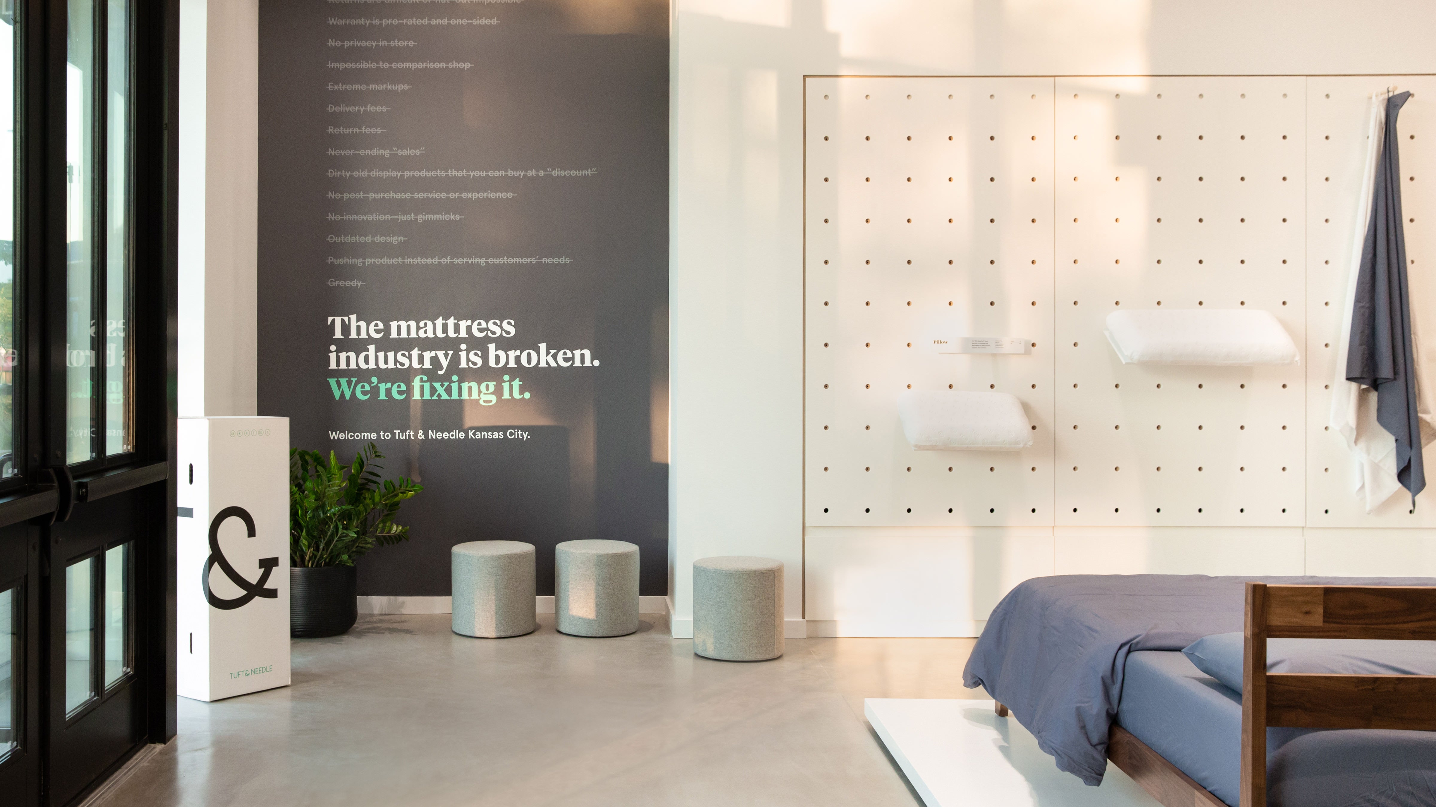 Picture of the inside wall of the Tuft & Needle Kansas City Mattress Store that has a welcome message