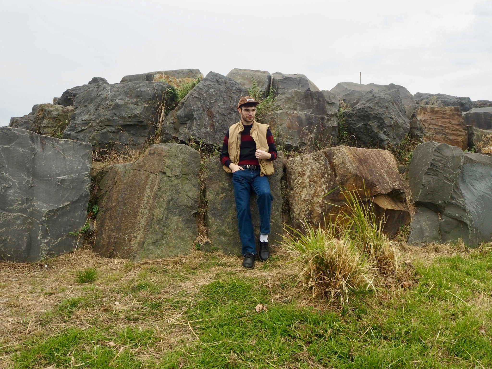 Ryan wears: Vintage corduroy cap, vintage striped sweater, vintage cargo vest, Levis 751 jeans, Dr Martens shoes. Photo by Kits Robertson.