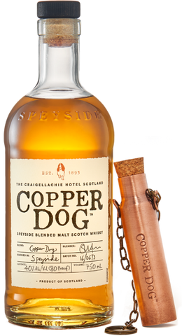 bottle of copper dog whisky with a copper flask leaning against it