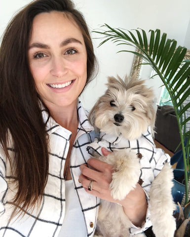 Dog Threads founder Gina and her first pup Thomas in matching white and black striped button ups