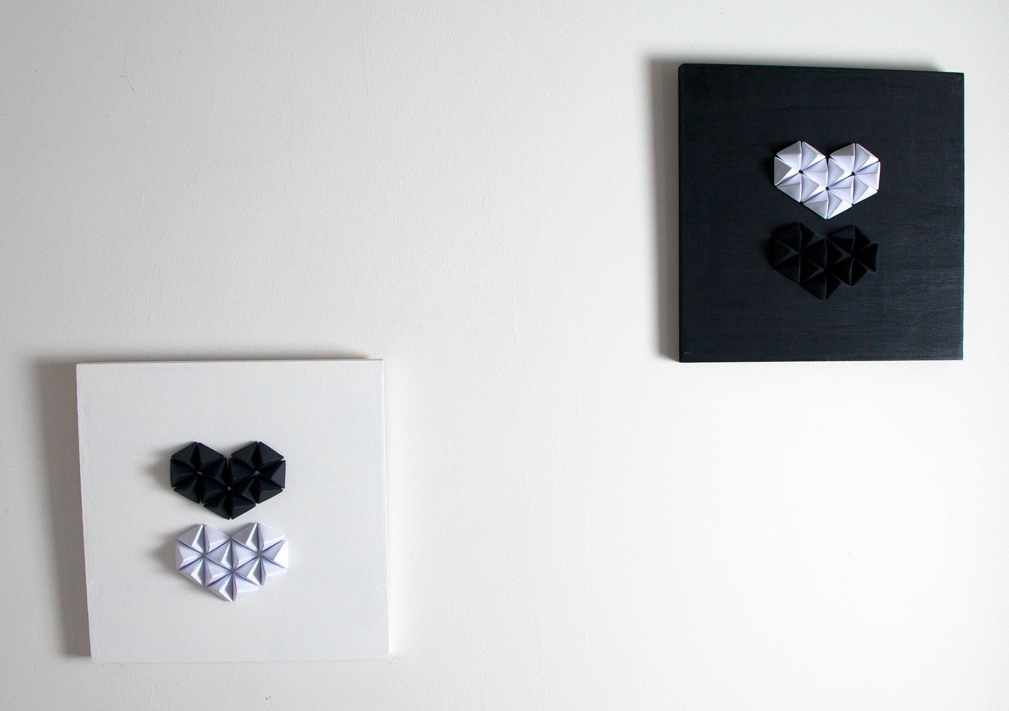 "Love Black, Love White" and "Love White, Love Black" artworks by unamarz. Folded paper and acrylic paint on wooden canvas.