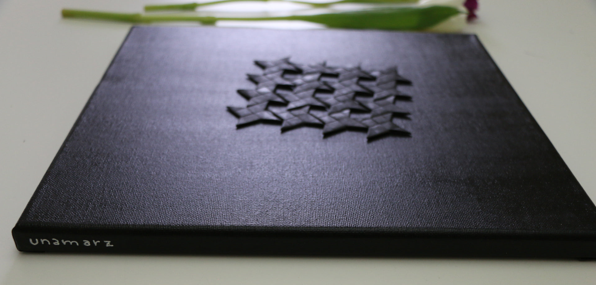 "Matrix Black", original artwork by unamarz, 16 black origami ninja stars, folded paper on black canvas