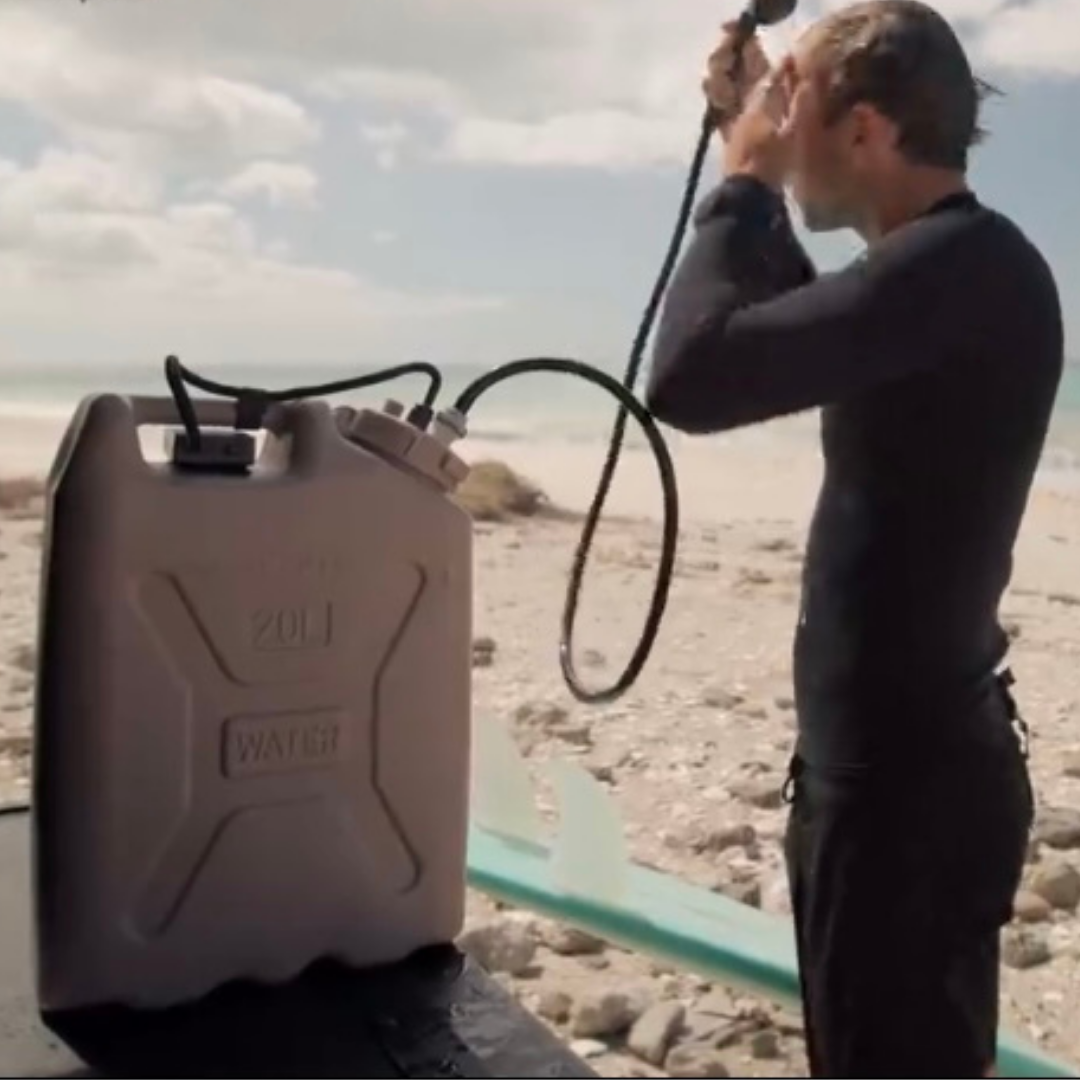 surfer taking a shower with sandycats trailwash system