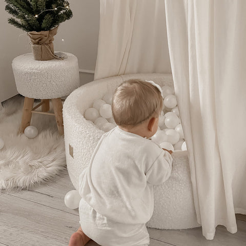 little boy playing with luxury soft boucle white ball pit from meowbaby