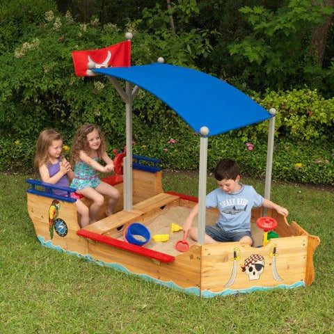 kidkraft pirate sandpit playset with children sitting in it
