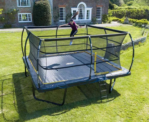 girl bouncing on telstar trampoline in garden