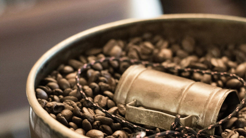 Freshly roasted coffee beans in a grinder, perfect for making a rich espresso.