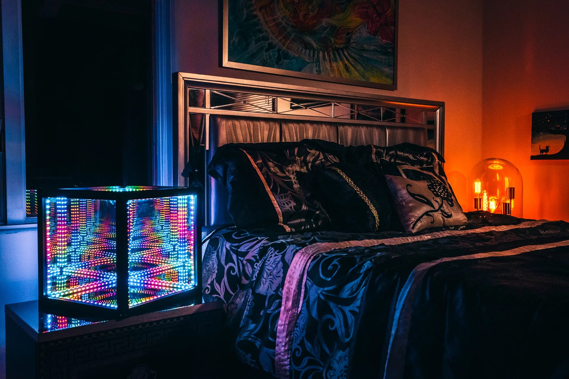 A bed in a room with a colorful bedside lamp, adorned with the best christmas lights.