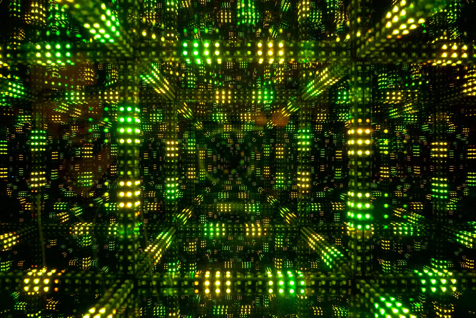 A festive display of green and yellow squares amongst twinkling Christmas lights.