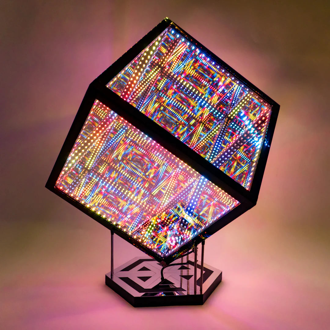 A vibrant cube lamp on a stand that emits colorful light for Halloween