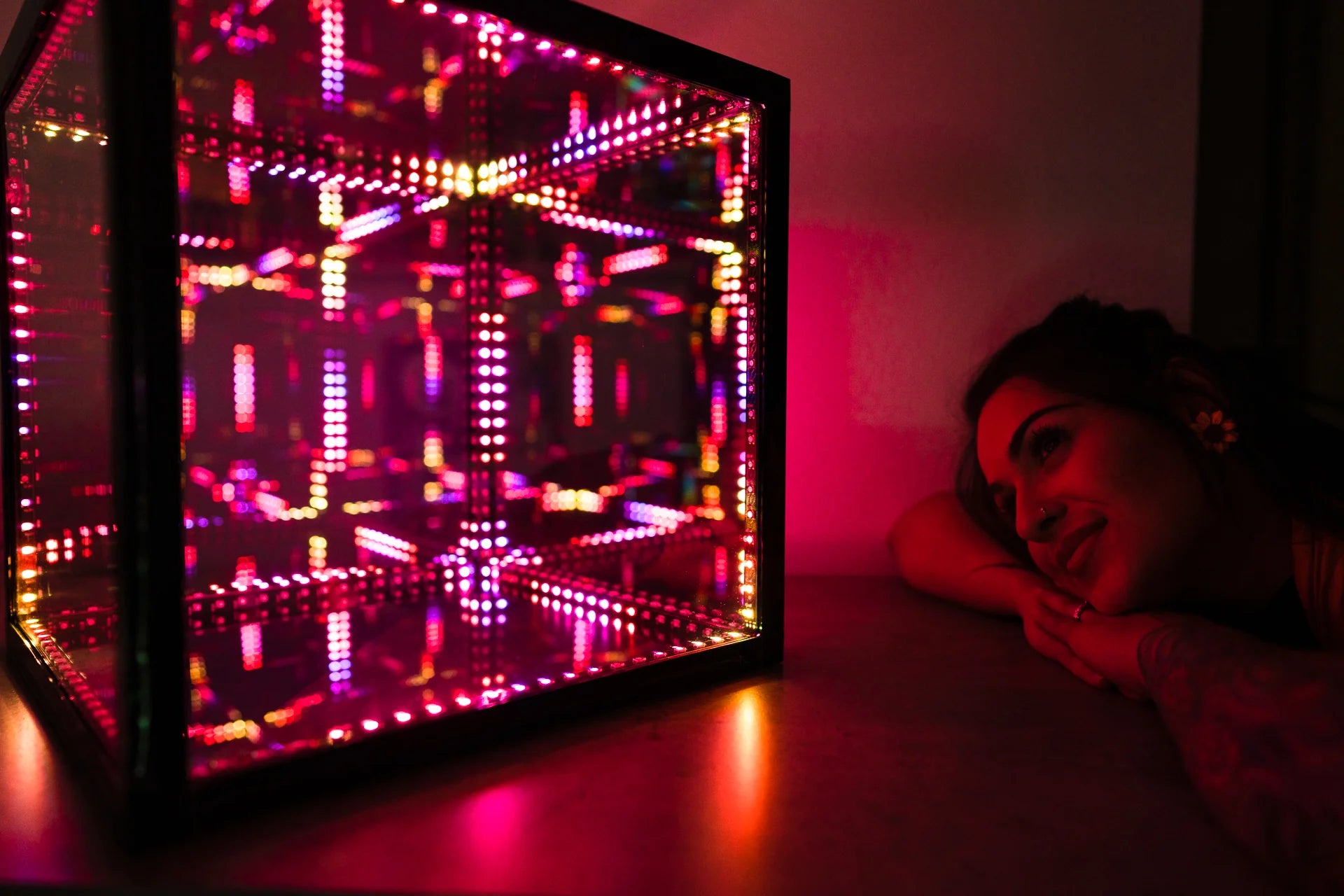 Woman leaning head on desk, looking at HyperCube decorative lighting for living room