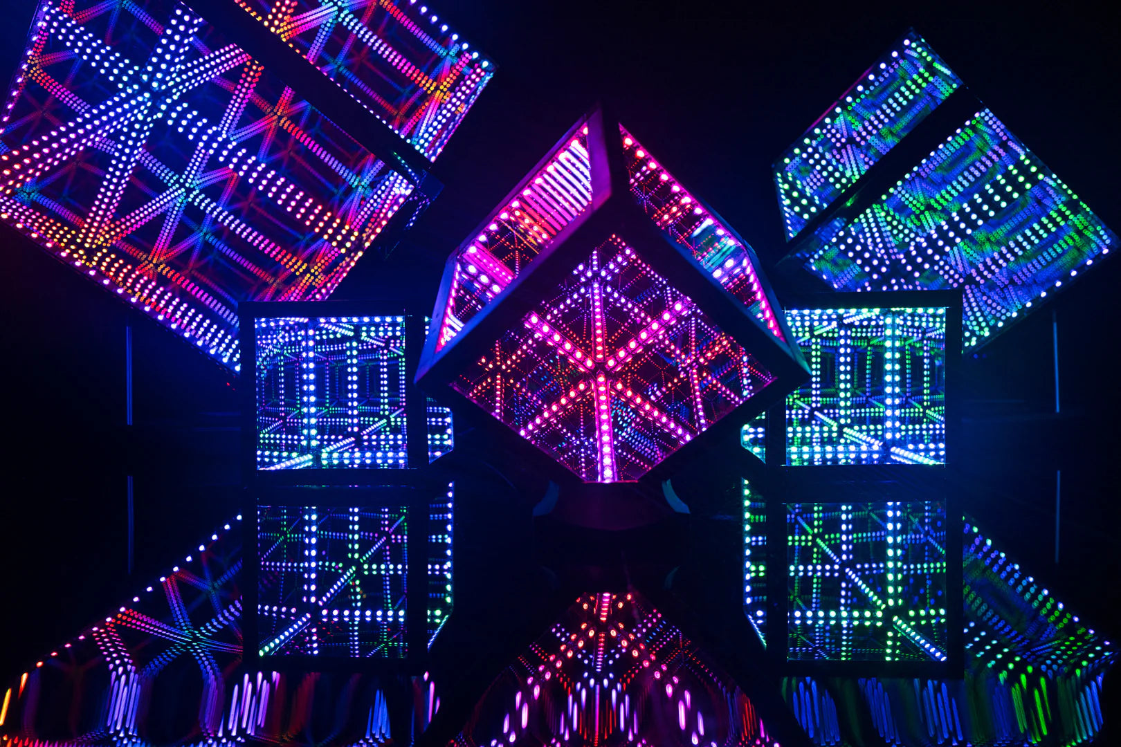 Five Hypercubes, all with different colored lights, placed on a table in a room with decorative lighting ideas