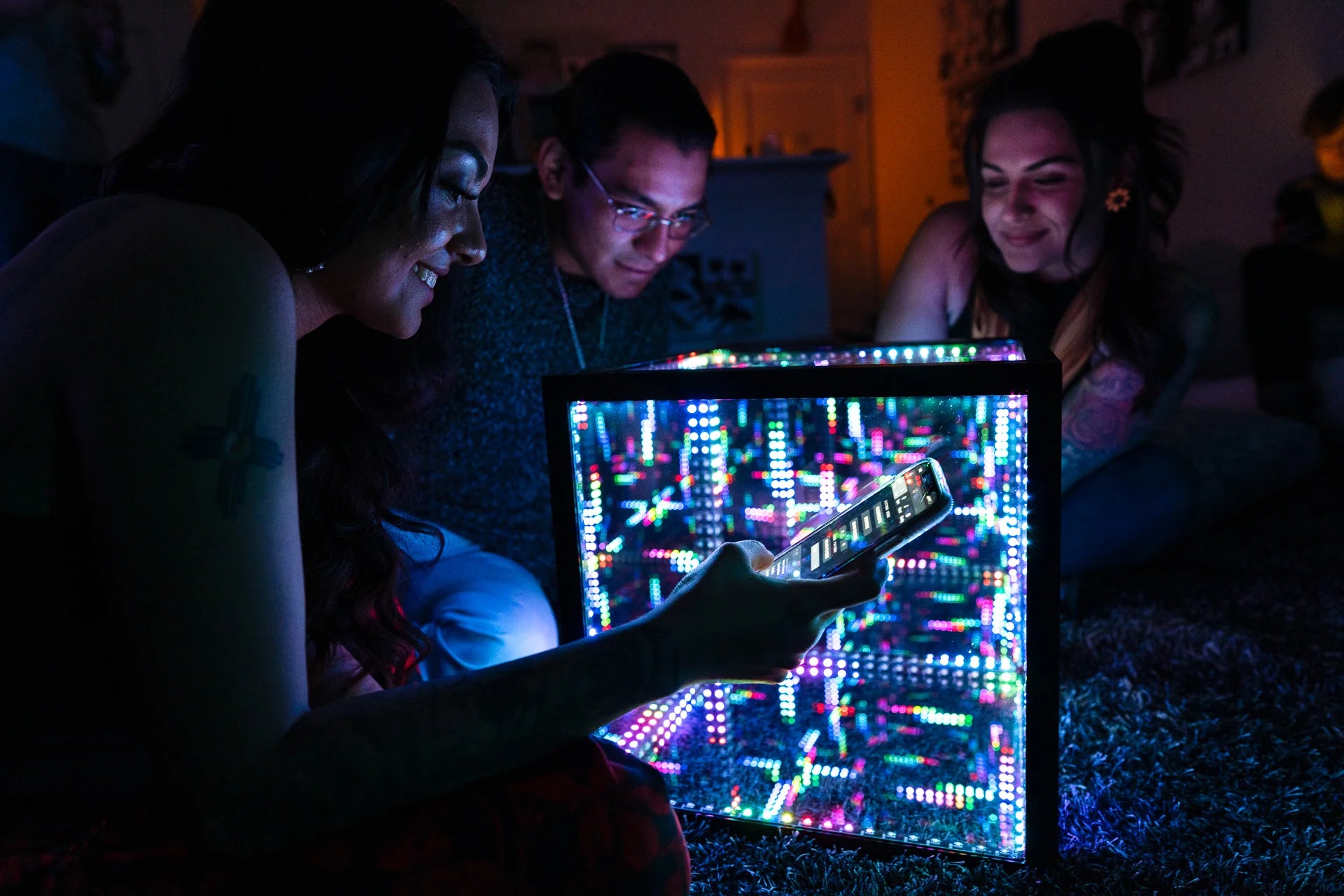 friends looking into color changing led light cube