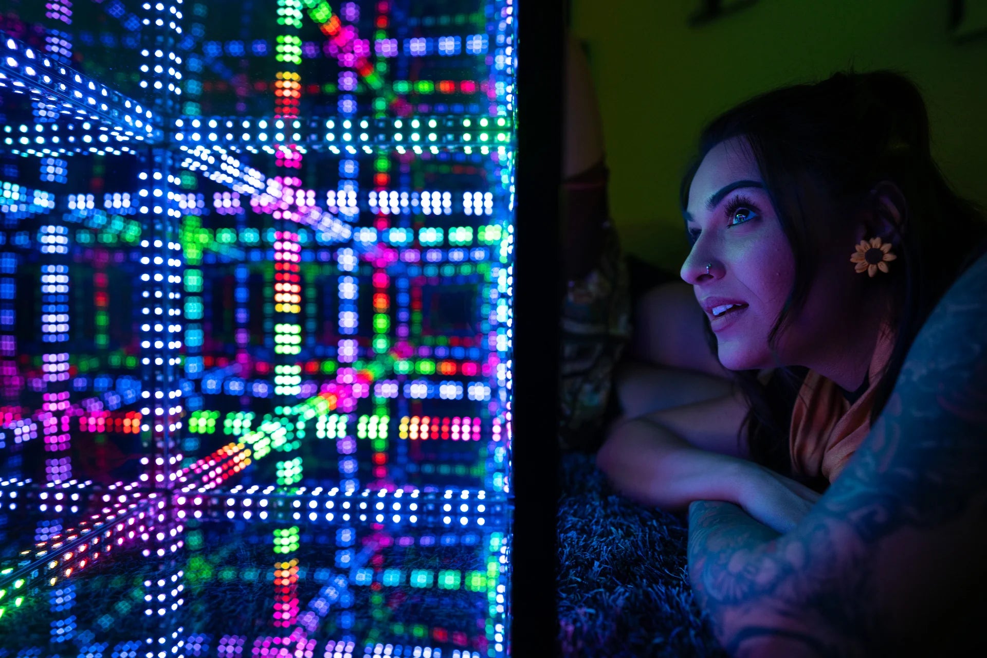 girl staring into cube with led light bulb
