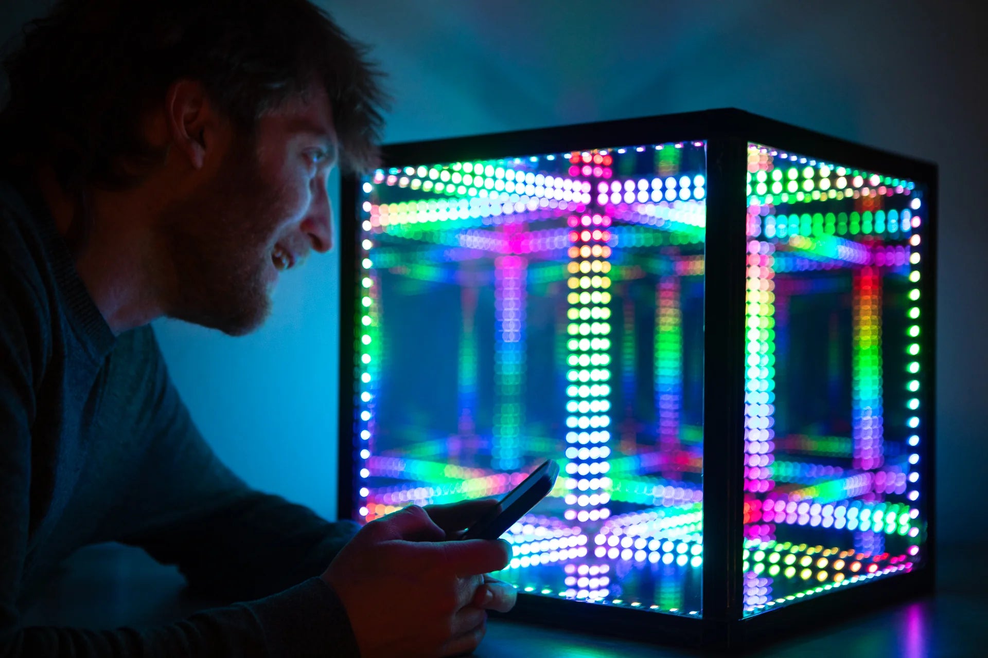 man changing the color of led cube