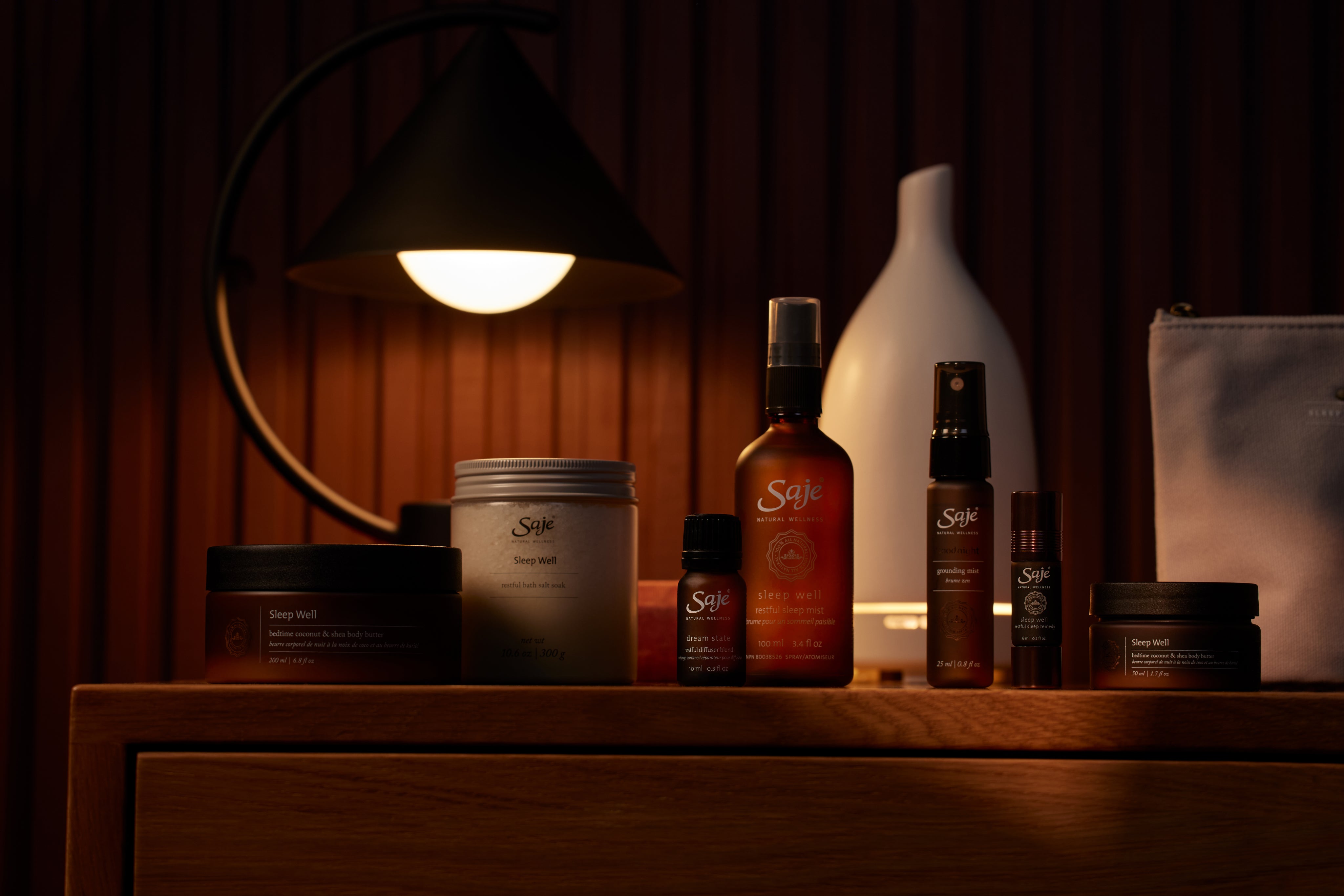 Sleep well products on a wooden table against a dim background