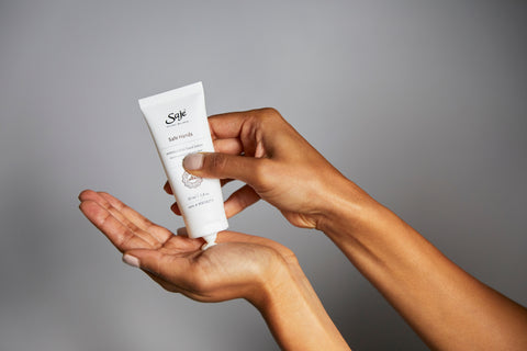 A person squeezing safe hands lotion into their palm