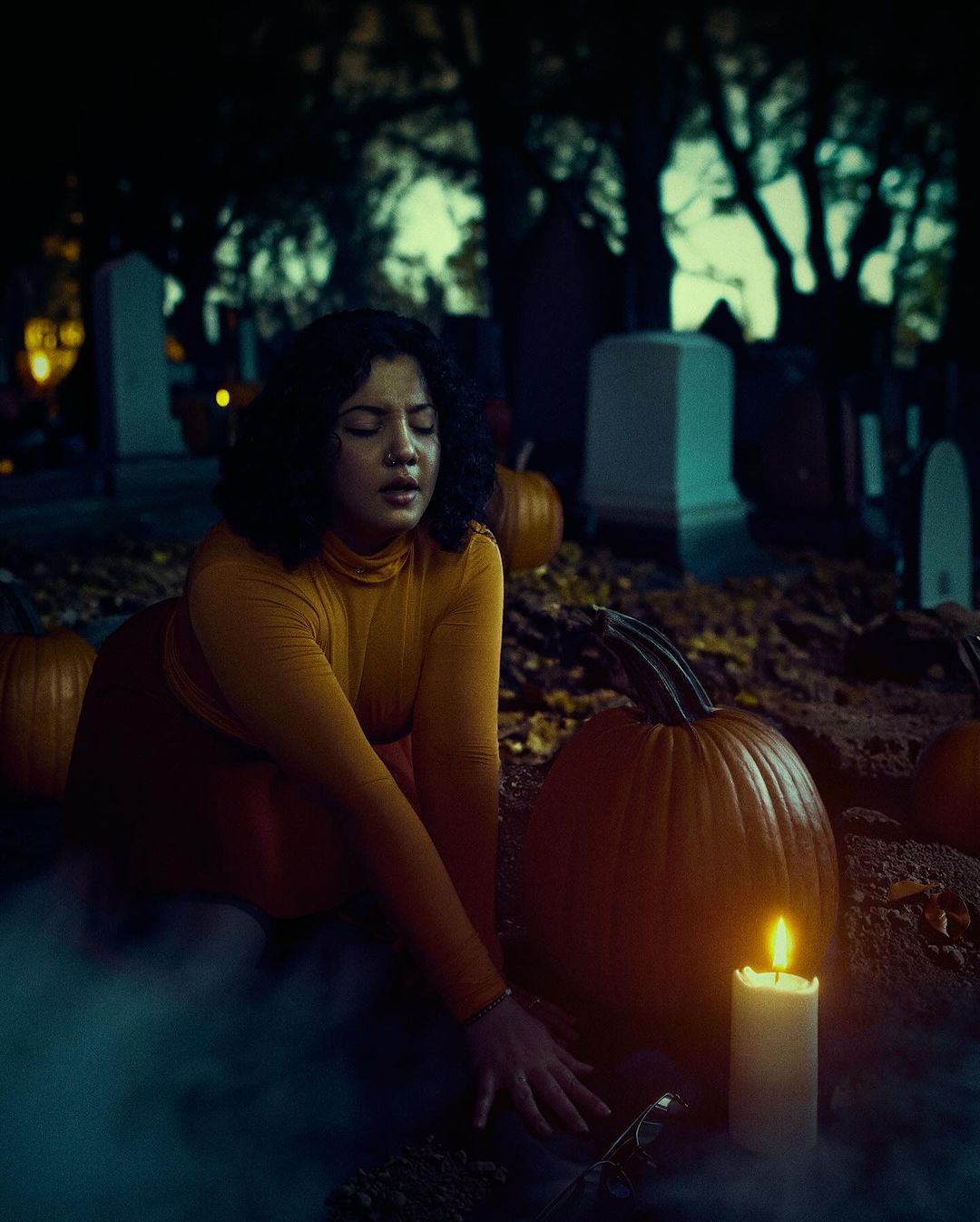 Creative photography by Jacklyn Lune inspired by Halloween and autumn season, young woman with candle, using color tones by onlythecurious