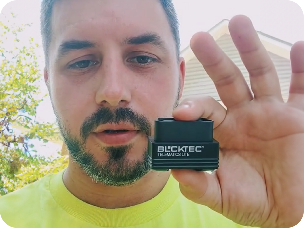 Man holding a BLCKTEC OBD2 Bluetooth code reader