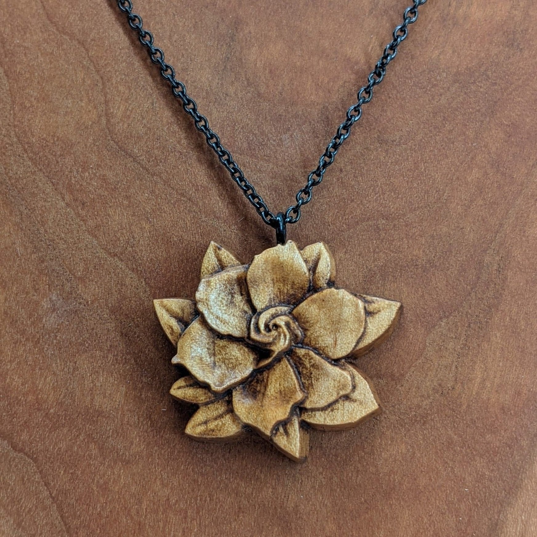 carved flower pendant