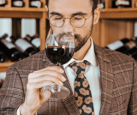 A man tasting wine
