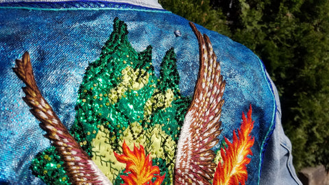 A close up of the top of the pegasus patch, showing off the detail of the wings and beaded applique bush.