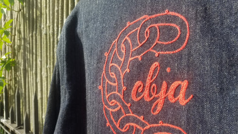 A closeup of the chainstitch embroidery on the backside of the denim work shirt. 