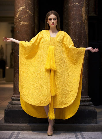 Model wearing the first cape ever made from spider silk