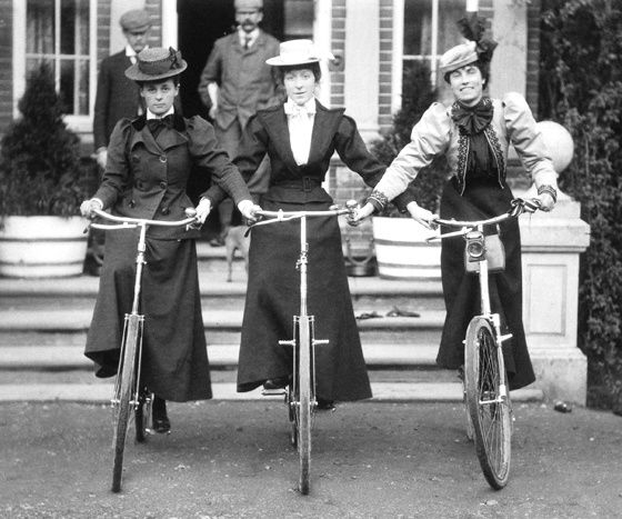 Three Gibson Girls riding bicycles side by side