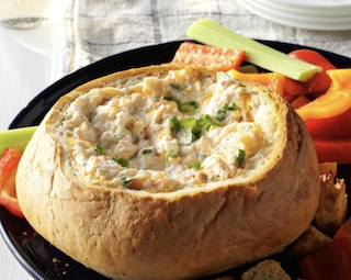 Dip inside of bread on a plate