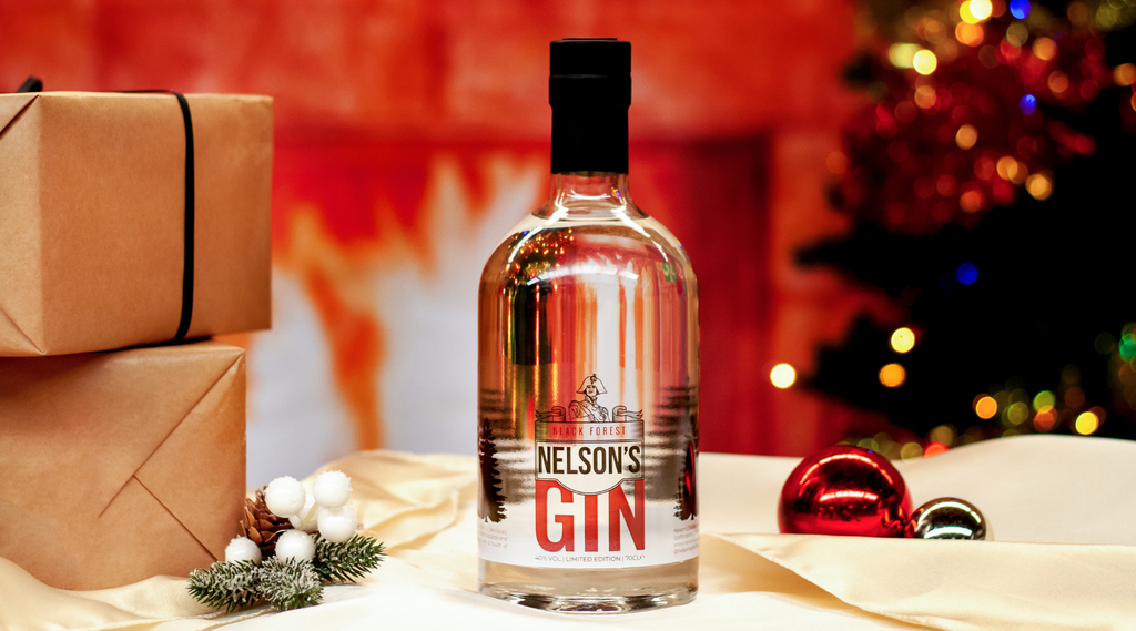Nelson's Black Forest Gin in front of Christmas themed background.