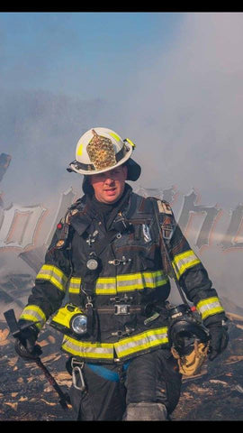 A fireman walks away from burning wreckage