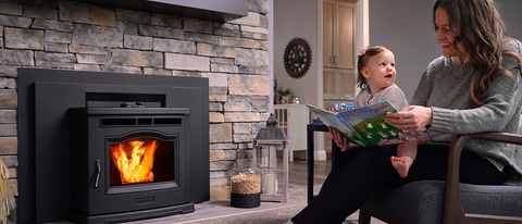 Image of mother and toddler reading in front of a Harman P42i-TC pellet fireplace insert