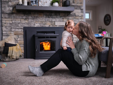 A photo of a mother and baby next to a Forge & Flame pellet fireplace insert