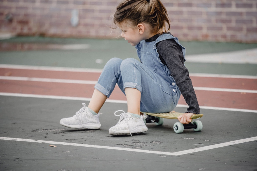 A girl learning to skateboard