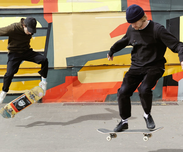 Two Men learning how to skateboard