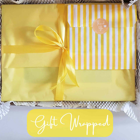 Framed Print gift wrapped in yellow tissue and ribbon, with a wrapped greeting card