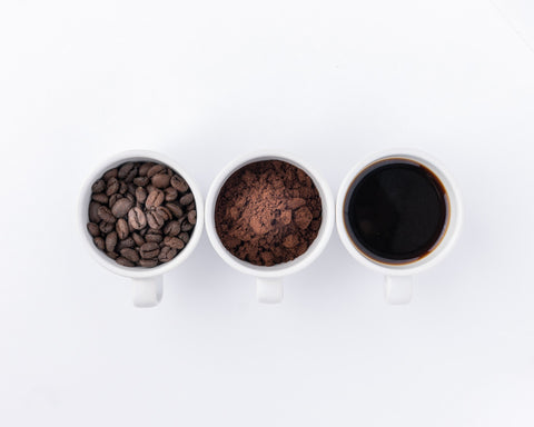 Three cups - one with Coffee beans, another one with ground coffee and last one with magical liquid known as black coffee