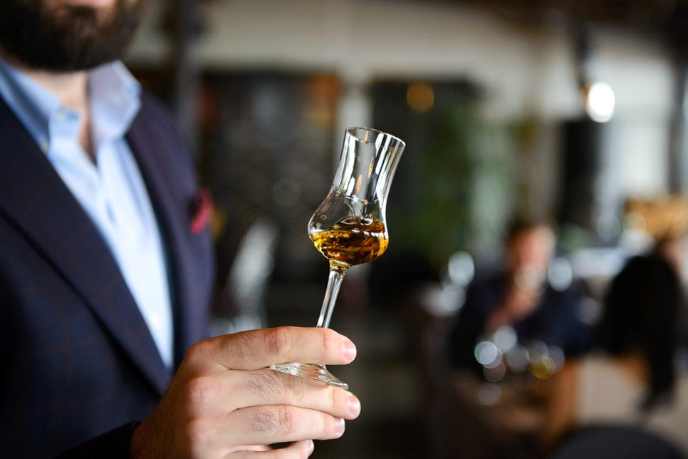 man holding whisky glass