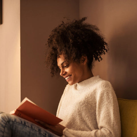 woman reading a B
book and smiling
