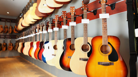 Guitars hanging on walls, two heights across two walls