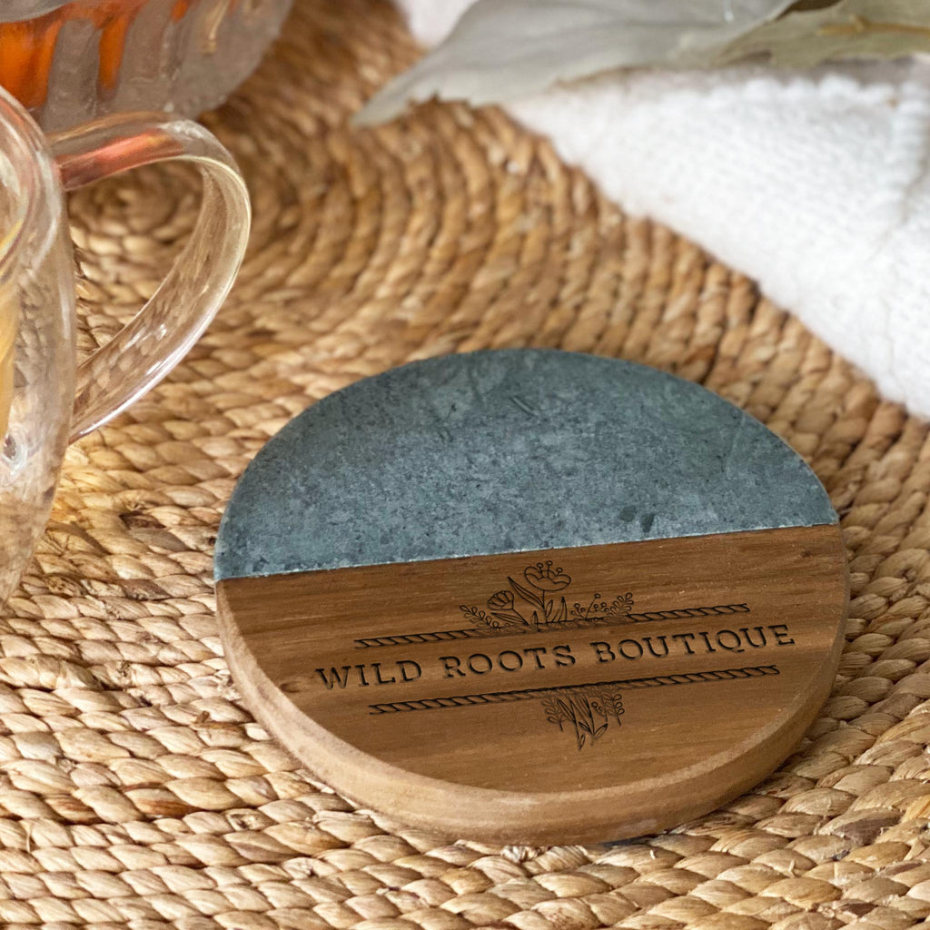 round shaped marble and wood coaster laser engraved with business logo of wild roots boutique