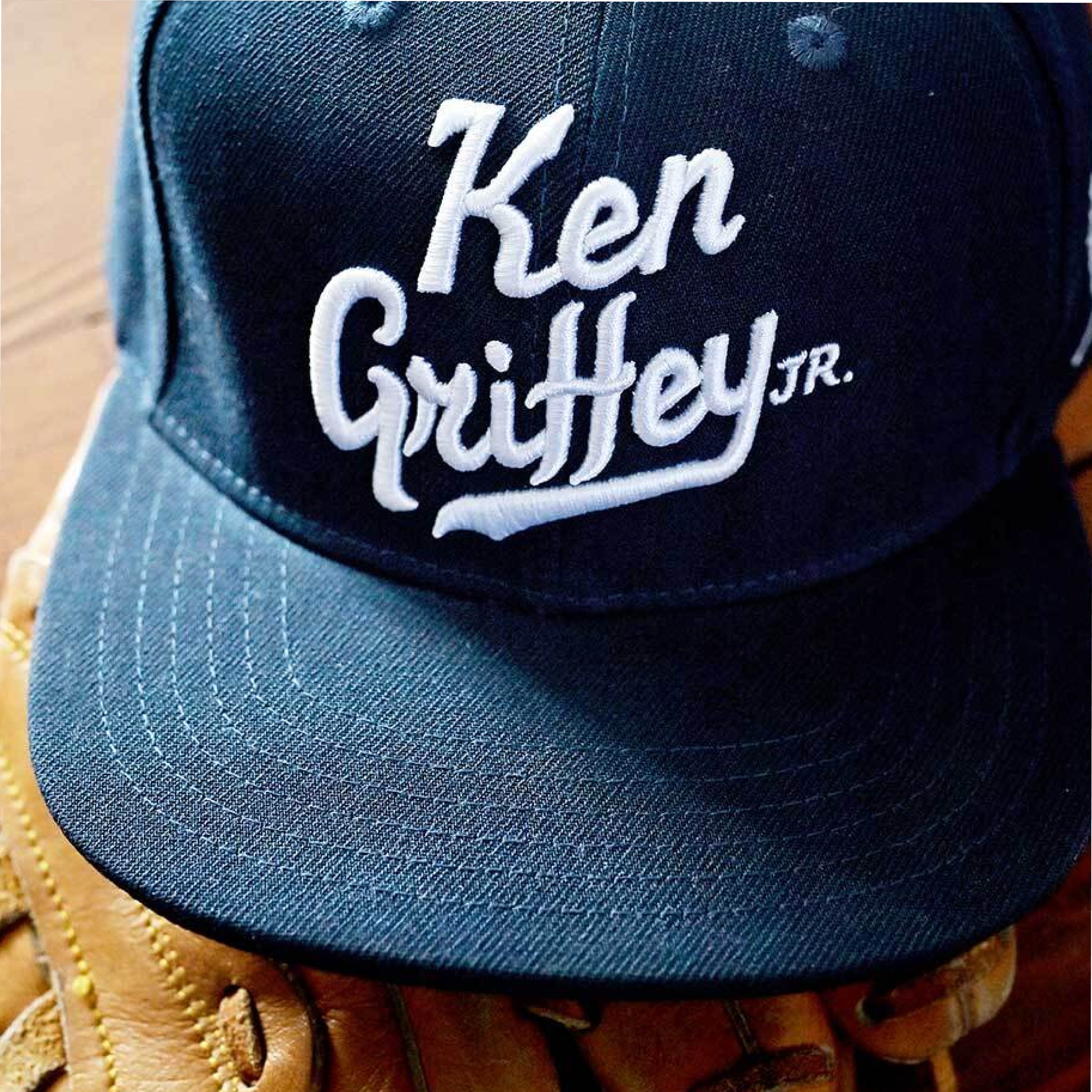 Navy blue baseball cap with 'Ken Griffey Jr.' embroidered in white on top of a baseball glove.